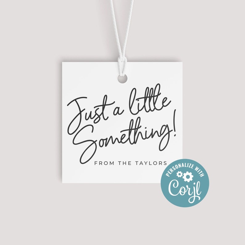 May include: White square gift tag with the text "Just a little Something!" in black script. The tag includes the text "FROM THE TAYLORS" and a teal circle with the text "PERSONALIZE WITH Corjl". A white string is attached.