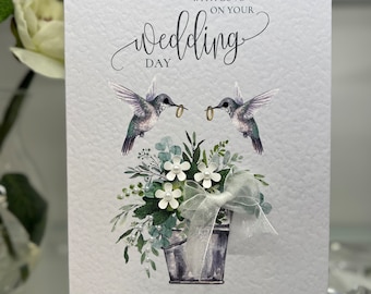 Personalised boxed wedding card with gift wallet, decorated with two humming birds and 3D paper flowers, gems & bow, printed on 300gsm card.