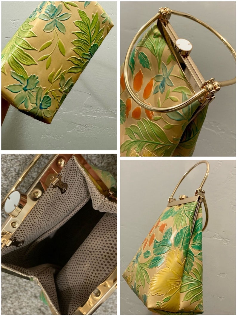 May include: A tan handbag with a floral design in green, blue, and orange. The bag has a gold-colored metal frame and handle. The interior lining is a dotted pattern.