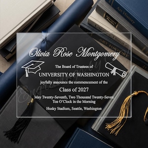 May include: A clear acrylic graduation announcement with the name "Olivia Rose Montgomery" and details for the University of Washington Class of 2027. The announcement is surrounded by books, a diploma, and a graduation cap.