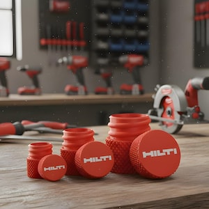 May include: A selection of red Hilti-branded tool accessories, including caps and cylindrical components, arranged on a wooden surface. The caps feature the Hilti logo in white. Other tools are visible in the background.