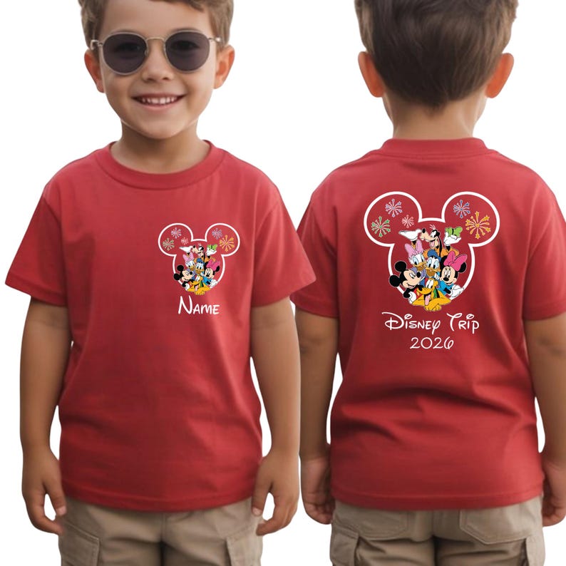 A young boy wearing a red Disney-themed t-shirt with Mickey Mouse and Minnie Mouse designs, along with the text "Disney Trip 2020".