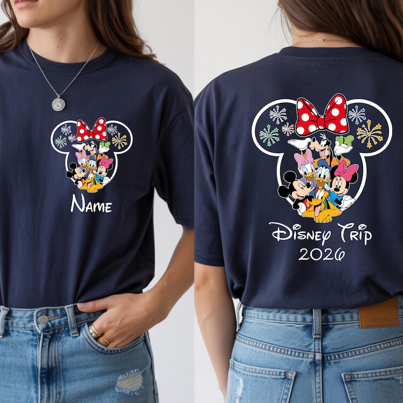A woman wearing a navy blue t-shirt with a Disney-themed design featuring Minnie Mouse, Mickey Mouse, Donald Duck, and Goofy. The t-shirt has a name printed on it and the text "Disney Trip 2020" printed on the back.