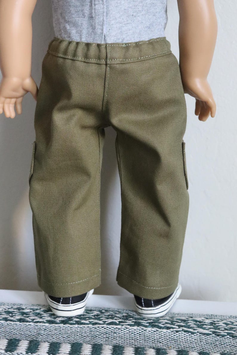 May include: Olive green cargo pants with a straight leg fit and two side pockets. The pants are made of a soft, durable fabric and are perfect for everyday wear.