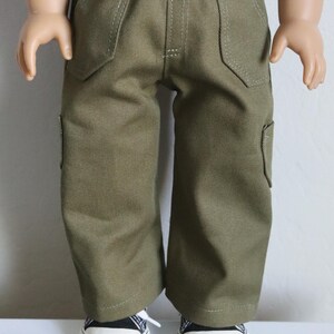 May include: Olive green cargo pants with a straight leg fit and multiple pockets. The pants are made of a soft, durable fabric and have a comfortable fit.