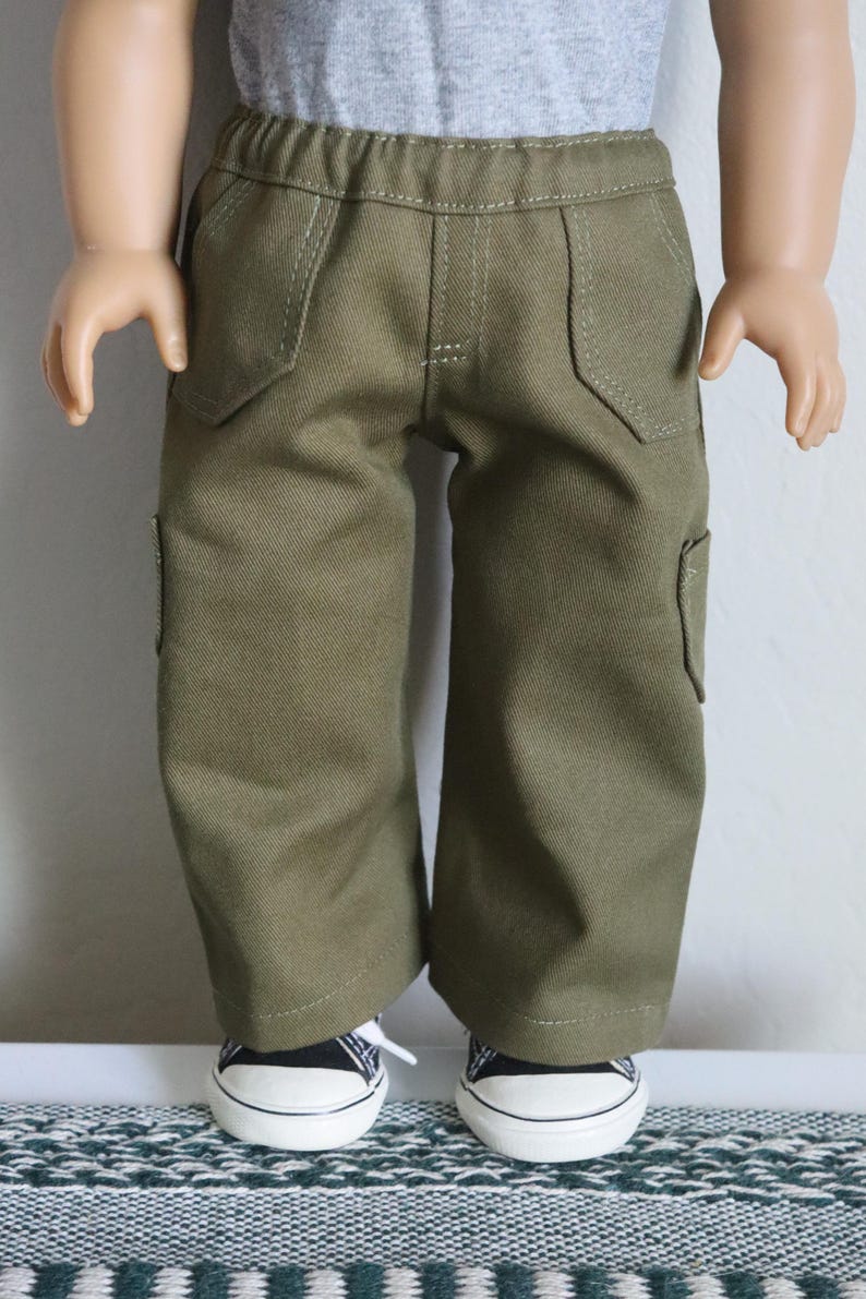 May include: Olive green cargo pants with a straight leg fit and multiple pockets. The pants are made of a soft, durable fabric and have a comfortable fit.