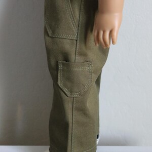 May include: Olive green cargo pants with multiple pockets and a straight leg fit.