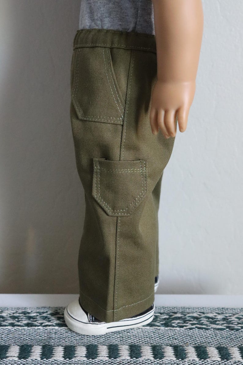 May include: Olive green cargo pants with multiple pockets and a straight leg fit.
