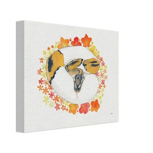May include: A square canvas print with a watercolour illustration of a ball python inside a broken egg. The snake has yellow and brown markings. The egg is encircled by a wreath of orange, yellow, and red flowers.