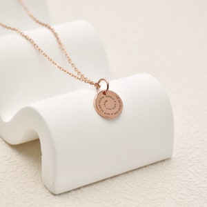 May include: A rose gold necklace with a round pendant that reads "When you have a dream, grab it and never let it go."