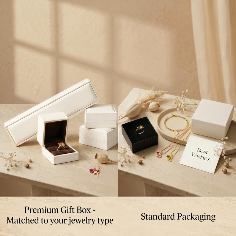 May include: A selection of jewellery gift boxes in different sizes and shapes. The boxes are white, with a black box holding a ring. A gold bracelet and necklaces are displayed on a tray. A card reads "Best Wishes".