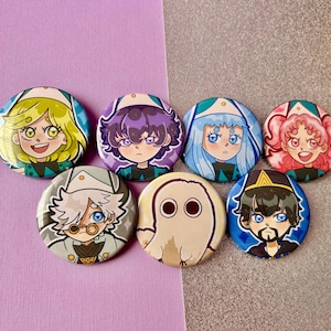 May include: A collection of seven round, colorful buttons featuring anime-style character illustrations. The buttons showcase various characters with different hair colors, facial expressions, and outfits, set against a purple and silver background.