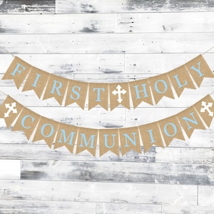 May include: A burlap banner with the words "First Holy Communion" in blue letters. The banner is decorated with white crosses.