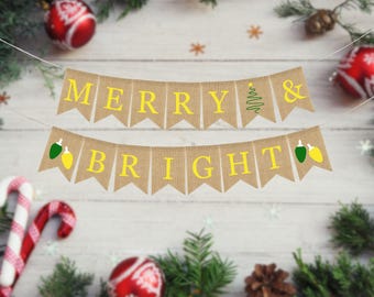 May include: A burlap banner with the words "Merry & Bright" in yellow letters. The banner is decorated with green and yellow light bulbs.