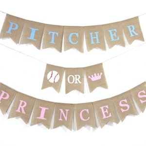 May include: A burlap banner with the words "Pitcher or Princess" in blue and pink letters. The banner is decorated with a baseball and a crown.