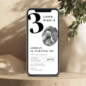 May include: A black and white birthday invitation on a smartphone screen. The invitation says "Look Who's 30!" and includes a photo of a young boy. The invitation also includes the text "Jordan is turning 30!" and details for the event, including the date, time, and location.