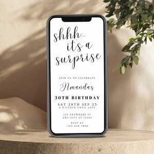 May include: A smartphone screen displaying a birthday party invitation with the text "shhh... it's a surprise" and details for Amanda's 30th birthday party on September 28th, 2023.