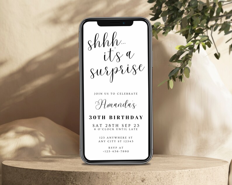 May include: A smartphone screen displaying a birthday party invitation with the text "shhh... it's a surprise" and details for Amanda's 30th birthday party on September 28th, 2023.