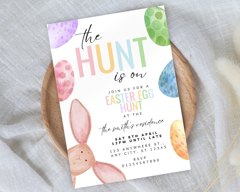 May include: A colourful invitation for an Easter egg hunt. The invitation features a bunny rabbit, pastel coloured eggs, and the text "the HUNT is on". The invitation also includes the date, time, and location of the event.