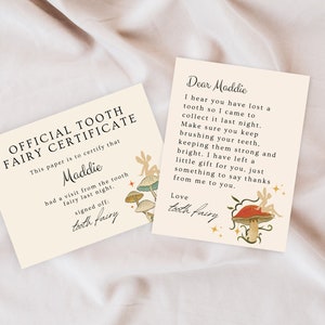 May include: A tooth fairy certificate with a whimsical illustration of fairies and mushrooms. The certificate reads "Official Tooth Fairy Certificate" and is addressed to Maddie. The text says "This paper is to certify that Maddie had a visit from the tooth fairy last night. Signed off: tooth fairy."