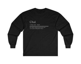 May include: Black long-sleeve t-shirt with a white graphic design that defines "Chai" as a noun. The definition reads: "Hot, milky, fragrant, gently spicy, and I am not just talking about chai."