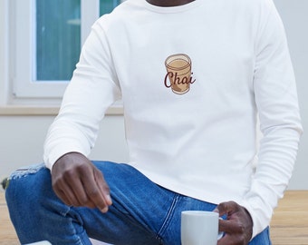 May include: A white long-sleeved shirt with a brown illustration of a glass of chai and the word "Chai" written in brown cursive.