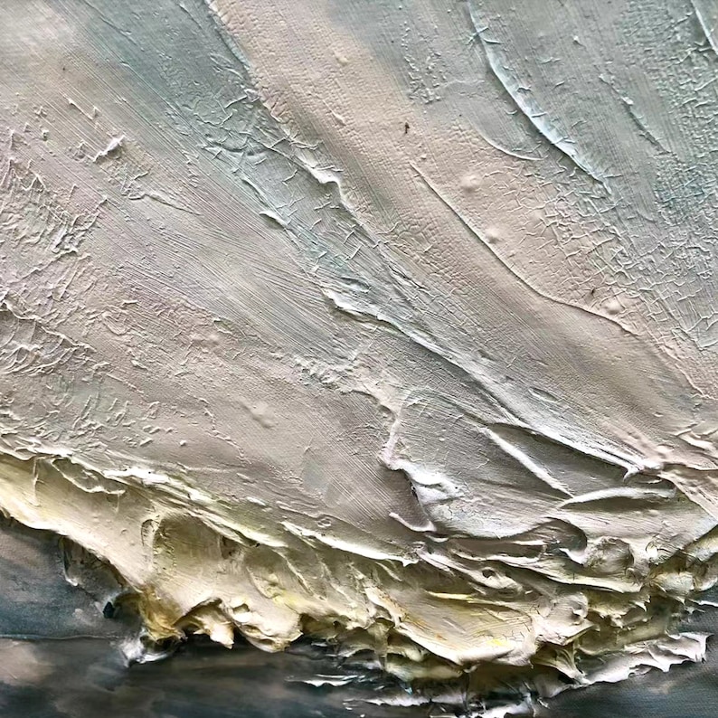 May include: Abstract painting with thick, textured brushstrokes in shades of white, gray, and light blue. The paint is applied in a swirling, dynamic pattern, creating a sense of movement and depth.
