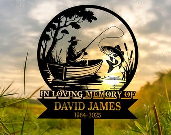 May include: A black metal memorial garden stake featuring a silhouette of a fisherman in a boat, with a fish jumping out of the water. The text reads "IN LOVING MEMORY OF DAVID JAMES 1964-2025".