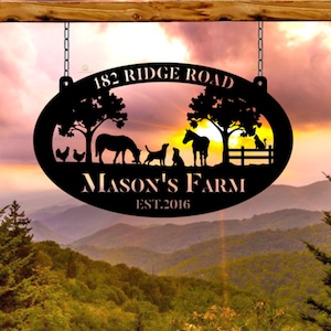 May include: Black metal oval sign with a sunset background. The sign reads "182 Ridge Road Mason's Farm Est. 2016". The sign also features a silhouette of a horse, two dogs, a chicken, and a cat.