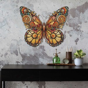 May include: A large, intricately designed butterfly wall decor with gold, red, and blue accents. The butterfly is made of metal and has a 3D effect.