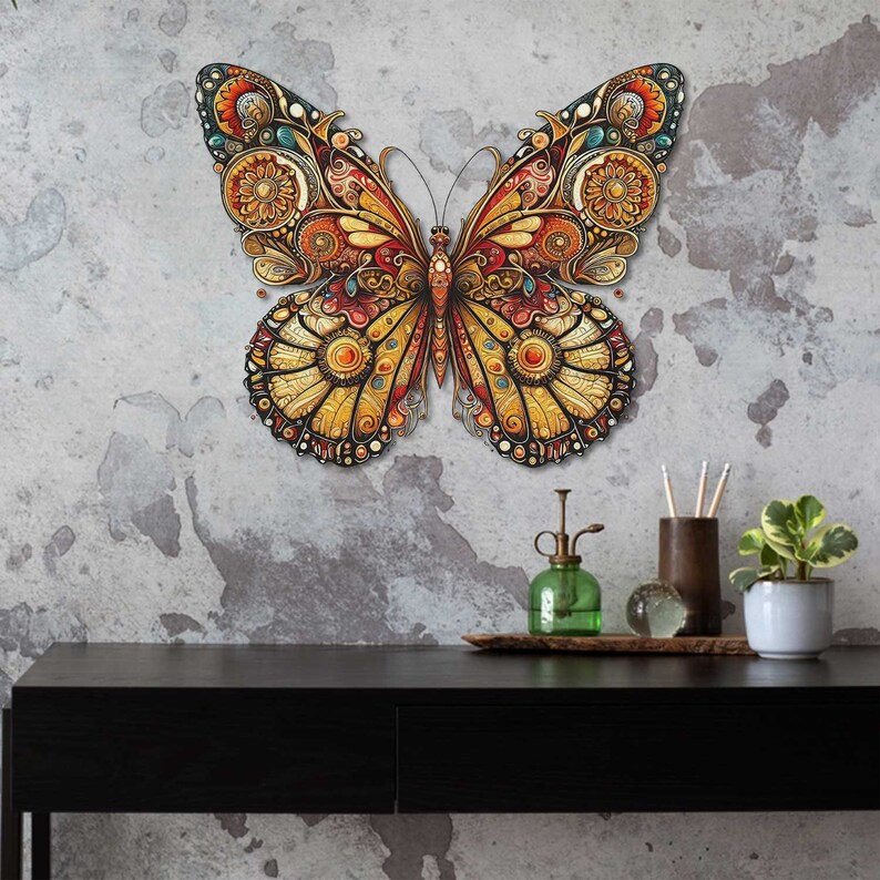 May include: A large, intricately designed butterfly wall decor with gold, red, and blue accents. The butterfly is made of metal and has a 3D effect.
