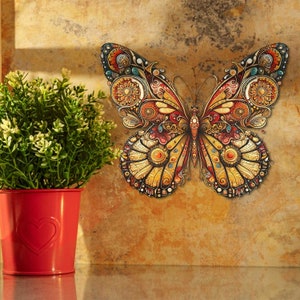 May include: A colourful butterfly wall decal with intricate details in shades of yellow, red, and blue. The butterfly is in a flying position with its wings spread wide.