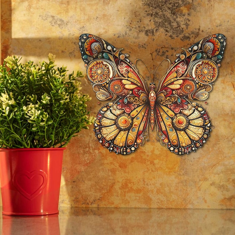 May include: A colourful butterfly wall decal with intricate details in shades of yellow, red, and blue. The butterfly is in a flying position with its wings spread wide.