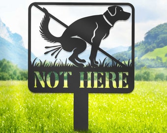 May include: Black metal sign with a silhouette of a dog pooping and a diagonal line through it. The sign reads "NOT HERE".