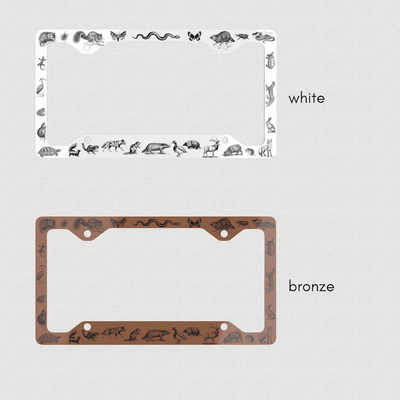 May include: Two license plate frames, one white and one bronze, with a black and white illustration of various animals around the border. The text "white" and "bronze" are printed below each frame.
