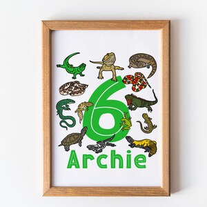 May include: A green number six surrounded by various reptiles and amphibians, including a lizard, a snake, a turtle, and a frog. The word "Archie" is written below the number.