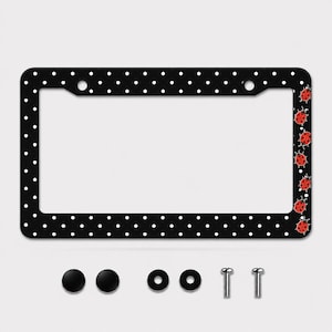 May include: A rectangular black license plate frame featuring a white polka dot pattern across the entire border. The right side of the frame is decorated with a vertical row of six red ladybugs. Includes two black screw covers and two screws.