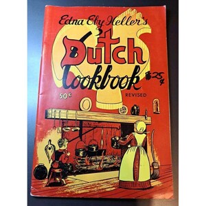 May include: A vintage cookbook cover with a red background and a yellow illustration of a Dutch oven. The title is "Edna Eby Heller's Dutch Cookbook" with the price "50¢" and "$25¢" printed on the cover. The text "REVISED" is also printed on the cover.