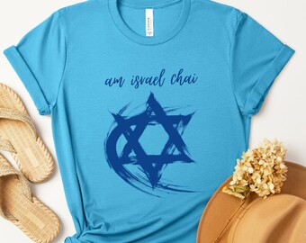 May include: A light blue t-shirt with a blue Star of David graphic and the text "am israel chai" in blue.