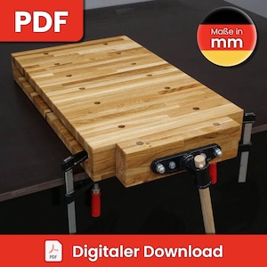 May include: A wooden workbench with a vise and a wooden handle. The workbench is made of light wood and has a natural finish. The vise is made of metal and has a black finish. The handle is made of wood and has a natural finish. The workbench is clamped to a black surface. The text "Maße in mm" is visible in the upper right corner of the image. The text "Digitaler Download" is visible in the lower right corner of the image.