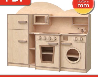May include: A wooden play kitchen with a white countertop, a stove with four burners, an oven, a sink, a refrigerator, and a washing machine. The kitchen is made of plywood and has a light wood finish. The text "Maße in mm" is visible on the image.