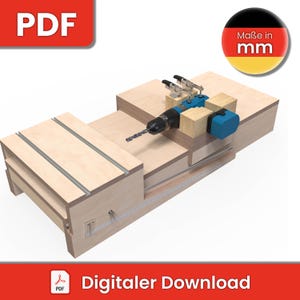 Könnte beinhalten: Eine Holzbearbeitungslehre zum Bohren von Löchern in Holz. Die Lehre besteht aus Holz und hat eine Bohrmaschine darauf montiert. Die Bohrmaschine ist blau und hat einen schwarzen Griff. Die Lehre steht auf einem Holztisch. Der Text "Maße in mm" ist in der oberen rechten Ecke des Bildes sichtbar.