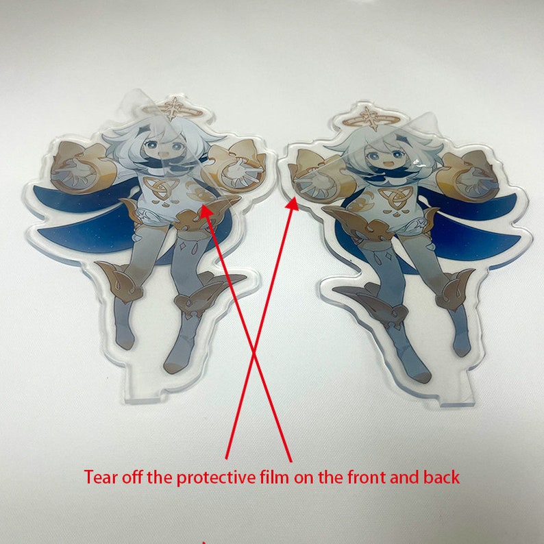 May include: Two clear acrylic character standees featuring a cartoon character with white hair, a white and gold outfit, and blue accents. The standees have a protective film and the text "Tear off the protective film on the front and back".