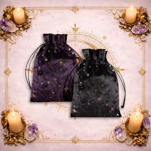 May include: Two velvet drawstring bags, one deep purple and one black, are adorned with gold star patterns. The bags are set against a decorative background with candles and crystals, creating a mystical aesthetic.