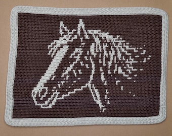 May include: A rectangular, crocheted blanket featuring a horse head design. The horse's head is white against a dark brown background. The blanket has a light gray border.