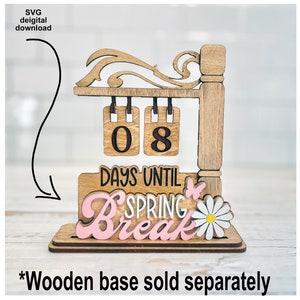 May include: Wooden sign with a countdown to spring break. The sign has two hanging numbers, 08, and the text "Days Until Spring Break". The sign is decorated with a butterfly and a daisy.