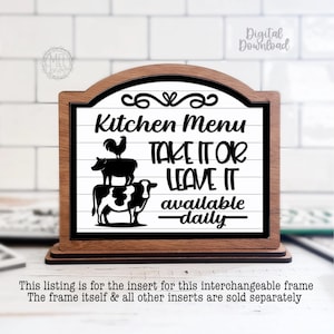 May include: Wooden kitchen sign with the text "Kitchen Menu TAKE IT OR LEAVE IT available daily." The sign features a black and white illustration of a rooster, a pig, and a cow. The sign is in a wooden frame.