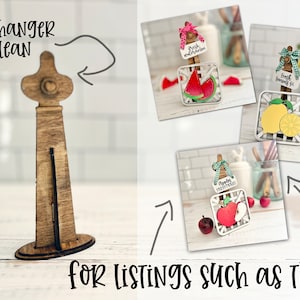 May include: Wooden sign hanger and leaner for displaying signs. The hanger is made of wood and has a natural finish. It is designed to hold signs that are up to 12 inches wide. The leaner is also made of wood and has a natural finish. It is designed to hold signs that are up to 10 inches wide.