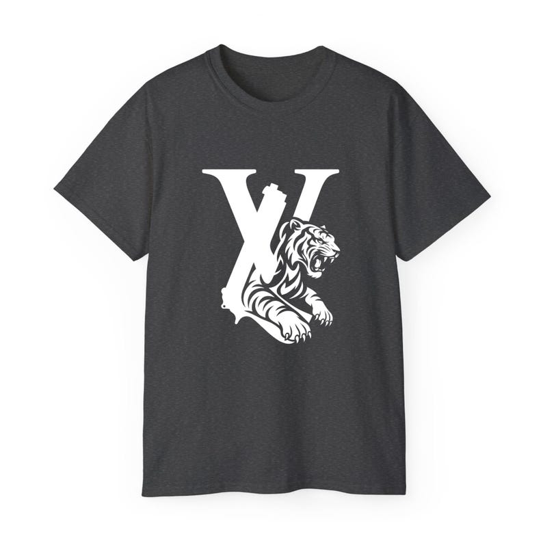 May include: Charcoal grey t-shirt with a white graphic. The graphic design incorporates the letter "X" and a detailed illustration of a tiger. The tiger is roaring, with its teeth bared, and is positioned within the letter's design.