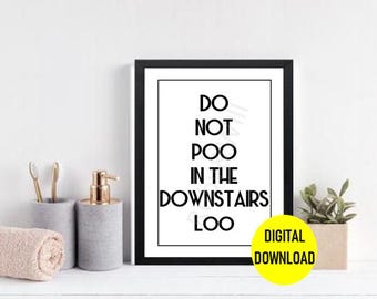 May include: A black and white printable sign with the text "Do not poo in the downstairs loo." The sign is framed in a black frame and has a yellow circle with the text "Digital Download" in the bottom right corner.